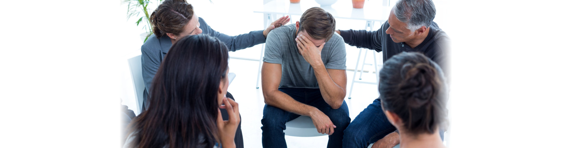 concerned patients comforting another in rehab group at a therapy session photo taken on: march 19th, 2015